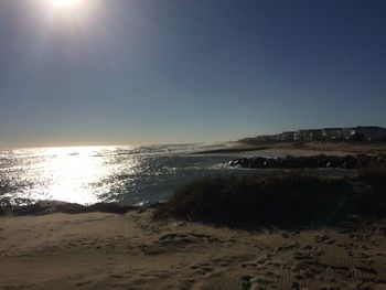 Scenic view of beach against clear sky