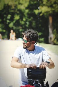 Man in sunglasses sitting outdoors