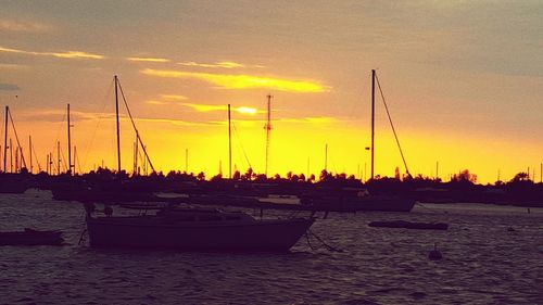 Sailboat in sea at sunset