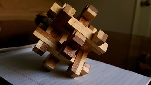 Close-up of wooden decoration on paper at table