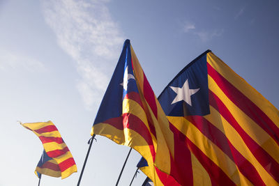 Low angle view of flag flags against sky