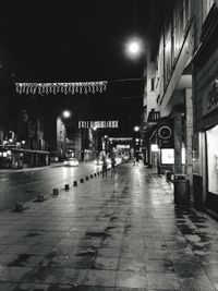 Illuminated city street at night