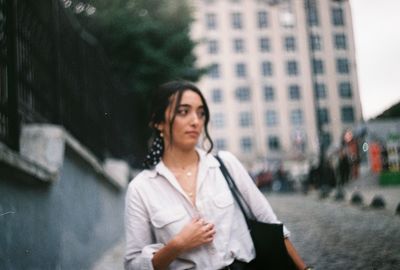 Portrait of beautiful young woman in city