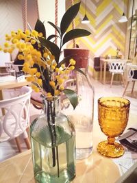 Close-up of orchids in vase on table at home