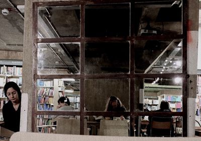 Reflection of people on glass window