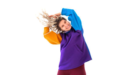 Smiling young woman against white background