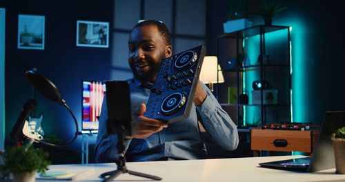 Young woman using mobile phone while sitting in cafe