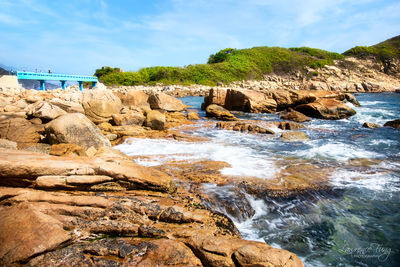 Scenic view of rocks in sea against sky