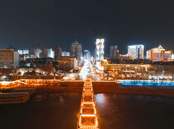 Illuminated modern buildings in city at night