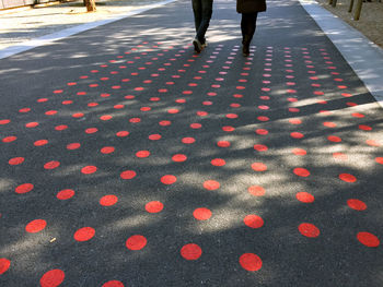 Low section of people walking on road