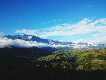 Scenic view of mountains against blue sky