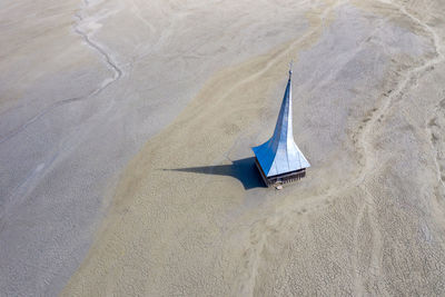 High angle view of umbrella on sand at beach