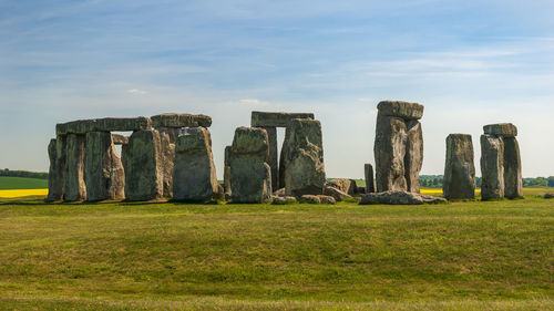 Stone structure on field against sky