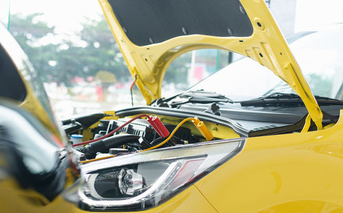 Close-up of yellow car on side-view mirror