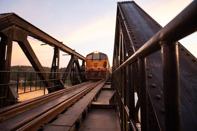 Train on bridge against sky