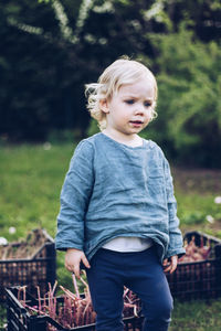 Cute baby girl standing in park