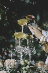 Close-up of hand pouring wine in glass