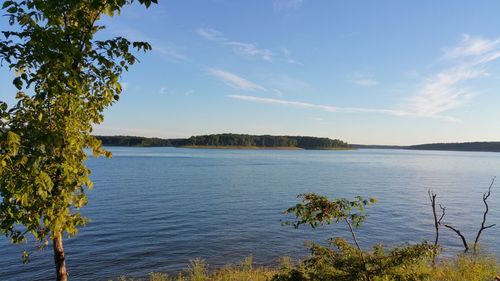 Scenic view of calm lake against blue sky