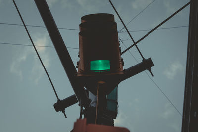 Low angle view of road signal against sky