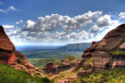 Scenic view of rock formation against cloudy sky