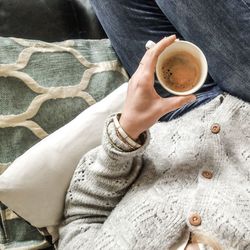 Midsection of man holding coffee cup