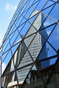 Low angle view of modern building against blue sky