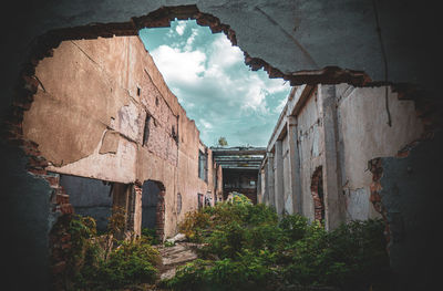 Low angle view of abandoned building against sky