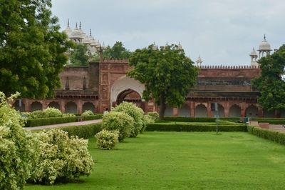 Lawn by agra fort against sky