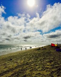 Scenic view of beach against cloudy sky