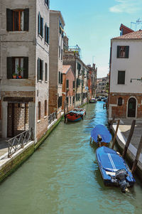 Canal overview with boats and buildings in the city center of venice, italy.