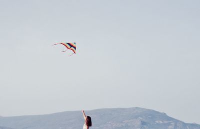 Person paragliding in sky