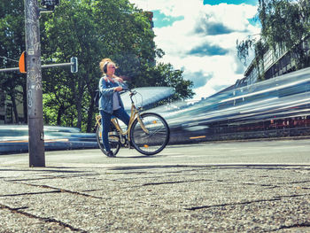 Man riding bicycle on road in city