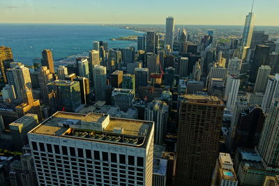 Aerial view of buildings in city against sky