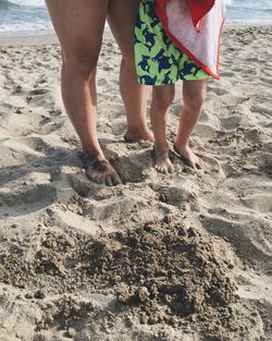 Low section of woman standing on beach