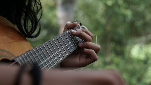 Close-up of hand playing guitar
