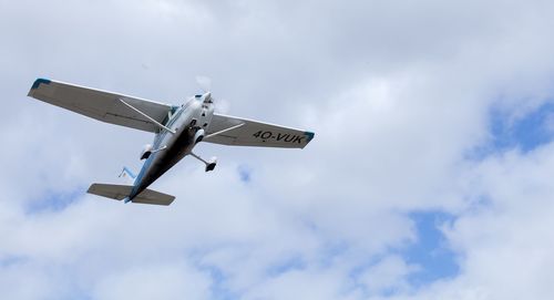 Low angle view of airplane flying against sky