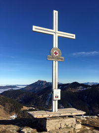 Information sign against blue sky