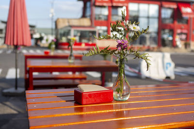 Decorative flowers in glass on table on bar terrace