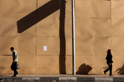 People walking on wall in city