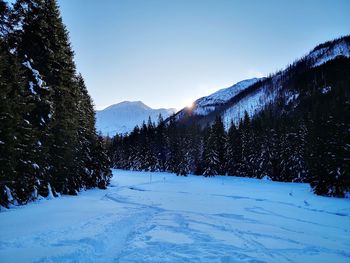 Scenic view of snow covered mountains against sky