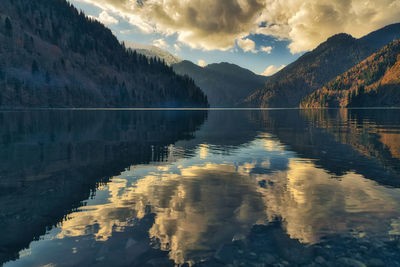 Scenic view of lake by mountains against sky