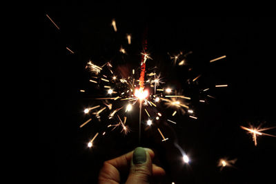 Low angle view of firework display at night