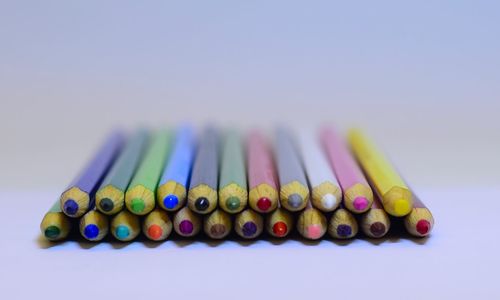 Close-up of colorful colored pencils over white background