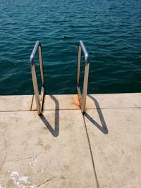 High angle view of railings on pier against sea