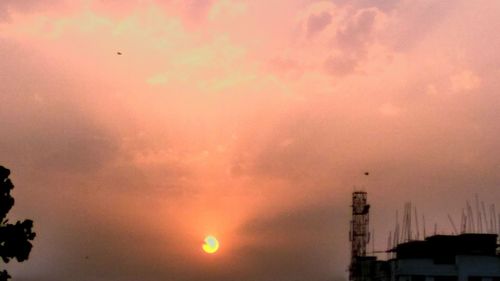 Silhouette cityscape against sky during sunset