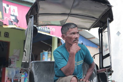 Portrait of young man sitting in store