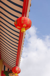 Low angle view of lanterns hanging against sky