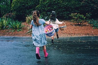 Full length of woman standing by railing