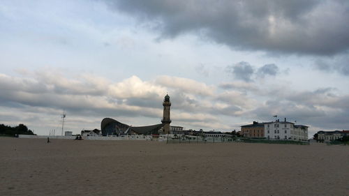 View of beach against cloudy sky