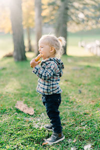 Portrait of boy standing on field